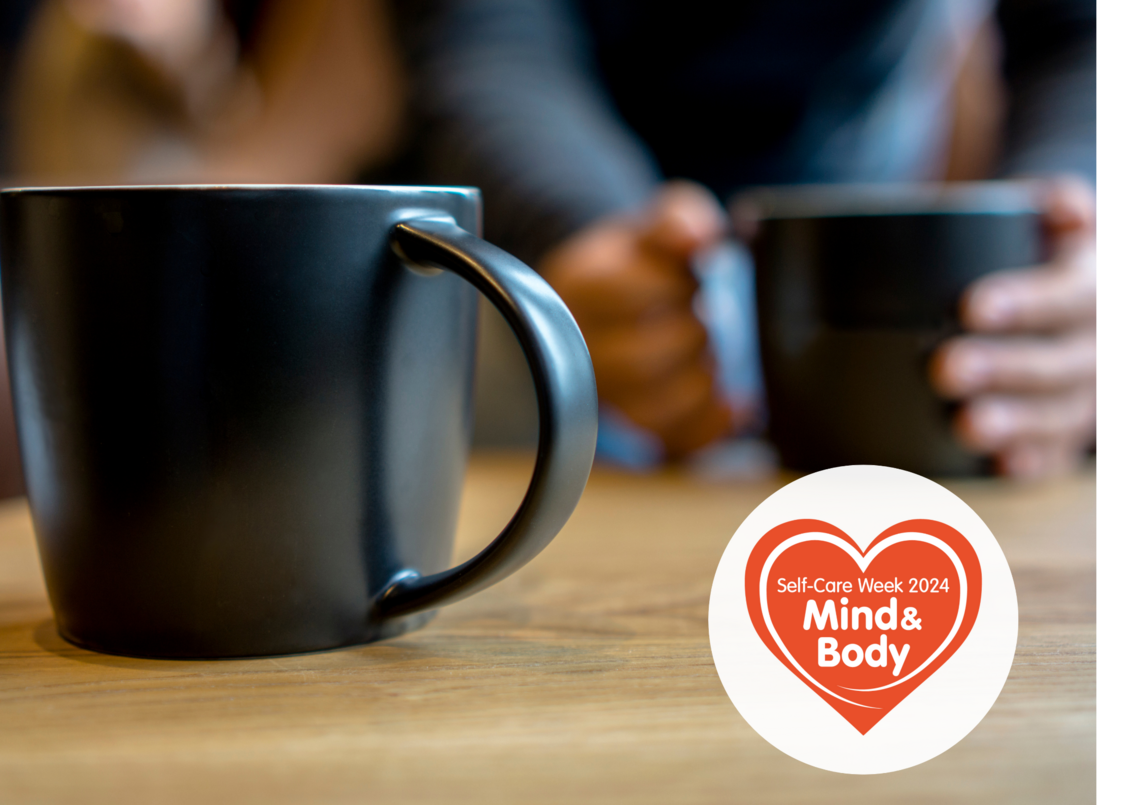 hands around a coffee mug on a table