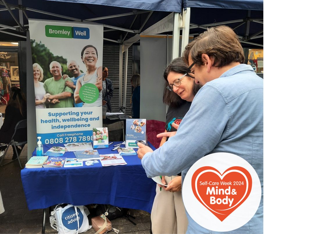 man and a woman talking about services at an outdoor market stand